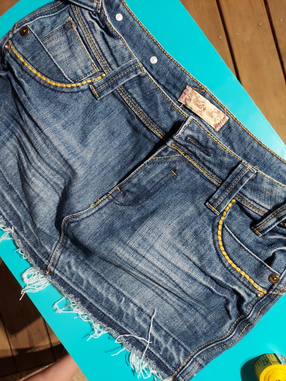 Vanilla Star Distressed Denim Mini Skirt with Yellow Topstitching And Fade